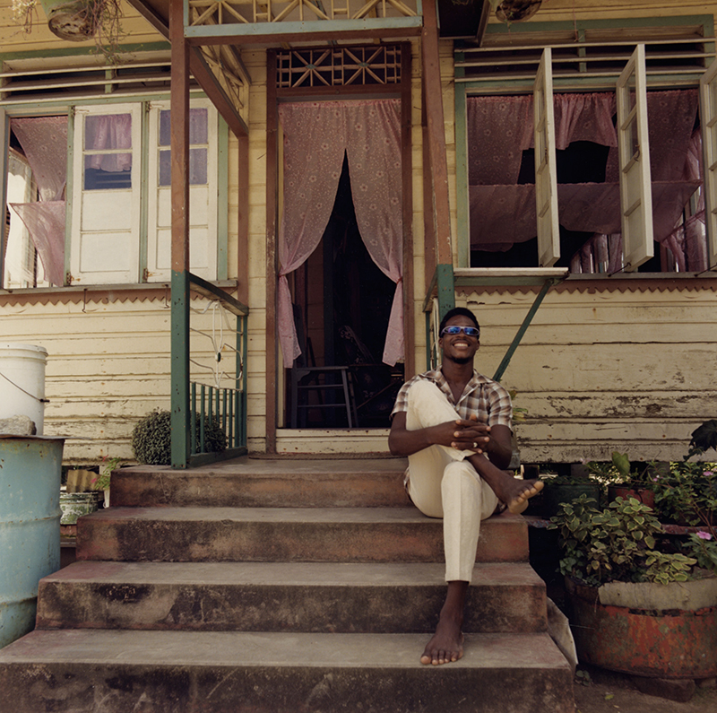 Untitled (man on porch) from Tobago, West Indies by Carol Fisher