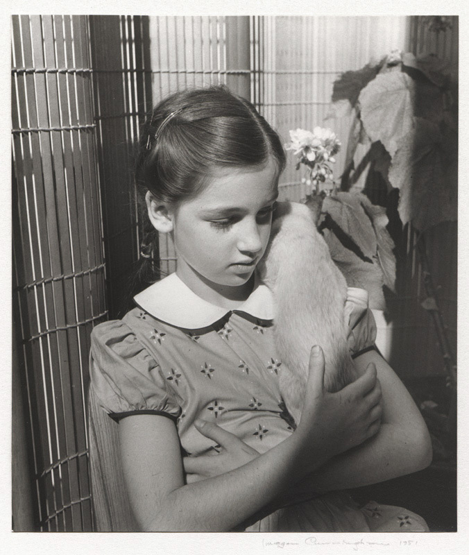 Girl holding Siamese cat by Imogen Cunningham